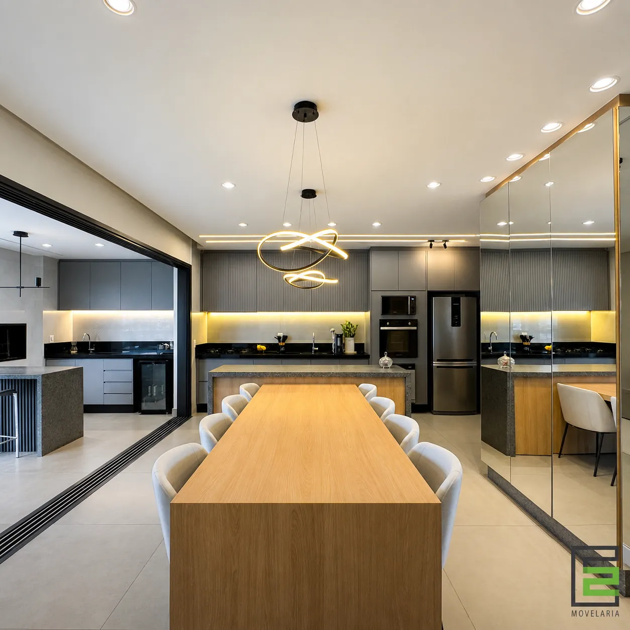 Cozinha integrada com ilha e mesa em madeira, projeto entregue pela E2